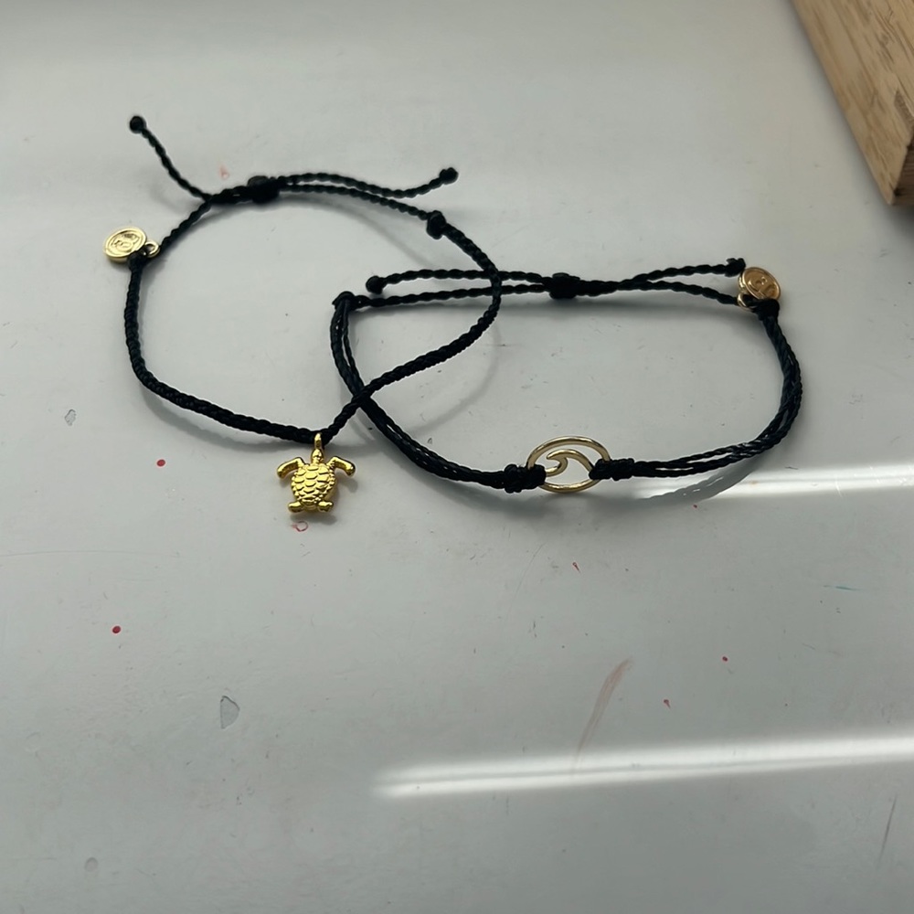 Black wave and turtle Pur Vida bracelet. Never been used before.Comes with both!